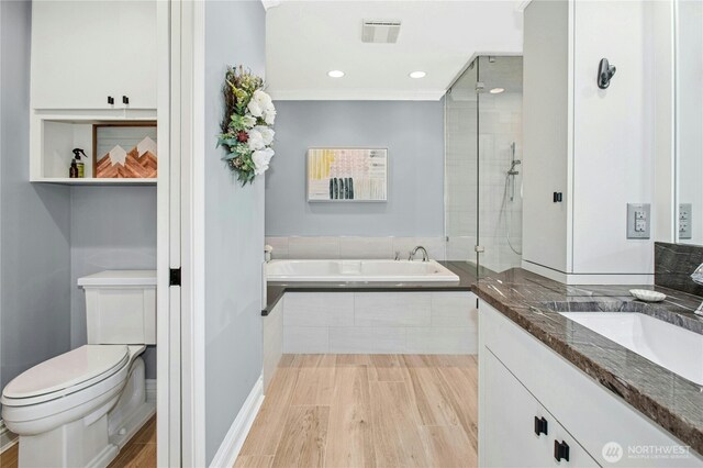 8150 Evergreen Ln, Mercer Island, WA 98040 - bathroom featuring a shower stall, wood finished floors, toilet, a bath, and recessed lighting