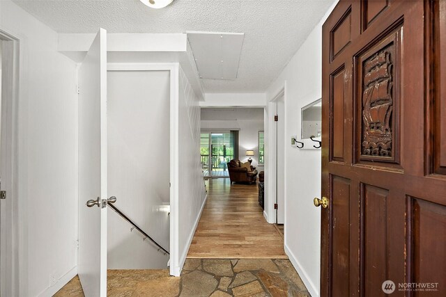 1812 5th St SE, Puyallup, WA 98372 - hall featuring a textured ceiling and baseboards