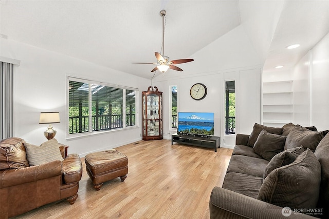 1812 5th St SE, Puyallup, WA 98372 - living room featuring a ceiling fan, light wood-type flooring, baseboards, and high vaulted ceiling
