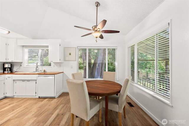 1812 5th St SE, Puyallup, WA 98372 - dining area with lofted ceiling, a ceiling fan, light wood-style floors, and baseboards
