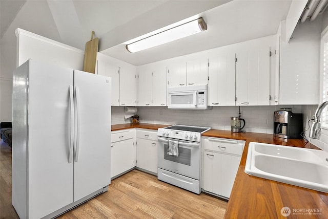 1812 5th St SE, Puyallup, WA 98372 - kitchen with white appliances, a sink, tasteful backsplash, white cabinets, and light wood-type flooring