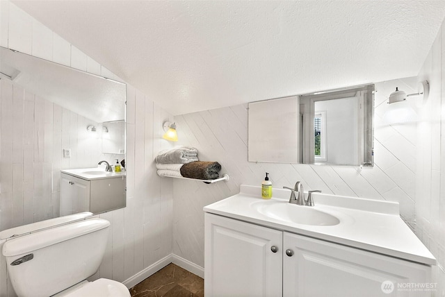 1812 5th St SE, Puyallup, WA 98372 - bathroom with toilet, vanity, a textured ceiling, and wooden walls