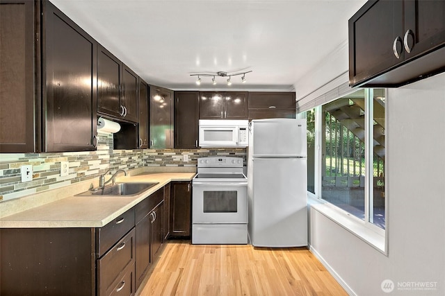 1812 5th St SE, Puyallup, WA 98372 - kitchen featuring white appliances, a sink, dark brown cabinetry, and light wood-style flooring