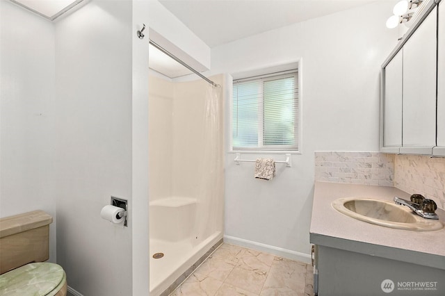 1812 5th St SE, Puyallup, WA 98372 - full bath featuring marble look tile flooring, a shower stall, baseboards, decorative backsplash, and vanity