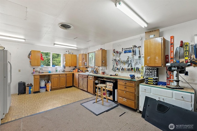 1812 5th St SE, Puyallup, WA 98372 - kitchen featuring freestanding refrigerator, brown cabinets, and light countertops