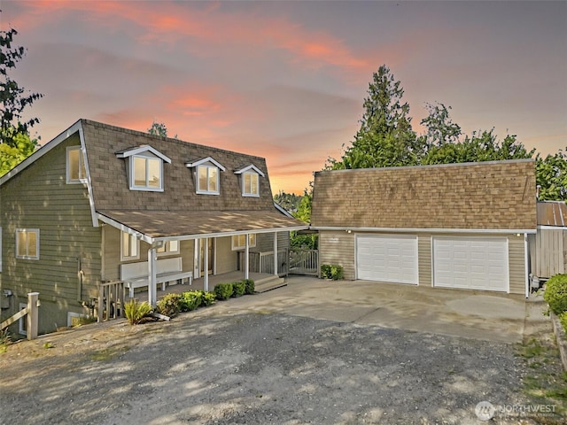 1812 5th St SE, Puyallup, WA 98372 - view of front of property with covered porch, concrete driveway, an outbuilding, a shingled roof, and fence