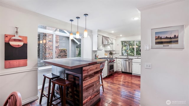 4017 239th Pl SE, Sammamish, WA 98029 - kitchen featuring appliances with stainless steel finishes, wall chimney range hood, white cabinets, ornamental molding, and dark wood-style floors