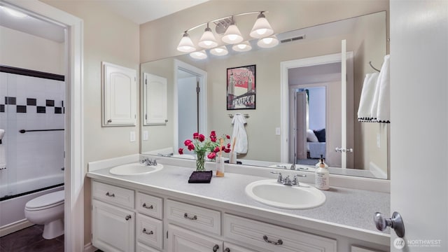 4017 239th Pl SE, Sammamish, WA 98029 - bathroom with toilet, double vanity, and bath / shower combo with glass door