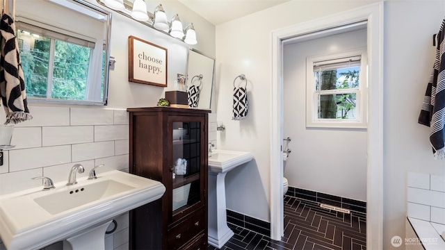 4017 239th Pl SE, Sammamish, WA 98029 - bathroom featuring healthy amount of natural light, toilet, a sink, and brick patterned floors