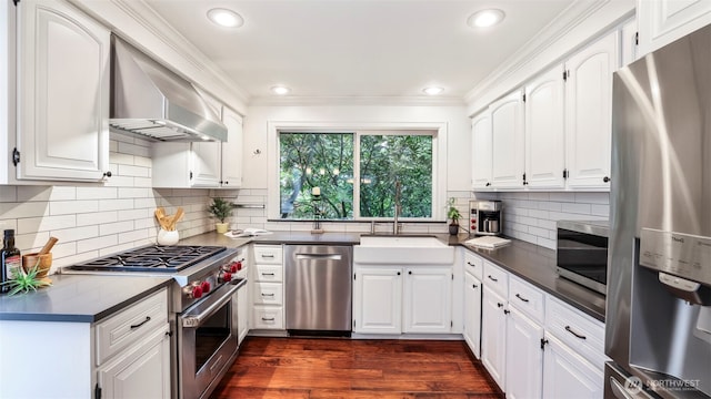 4017 239th Pl SE, Sammamish, WA 98029 - kitchen featuring appliances with stainless steel finishes, wall chimney exhaust hood, a sink, dark countertops, and ornamental molding