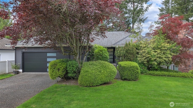 4017 239th Pl SE, Sammamish, WA 98029 - view of property hidden behind natural elements featuring a front lawn, asphalt driveway, and an attached garage