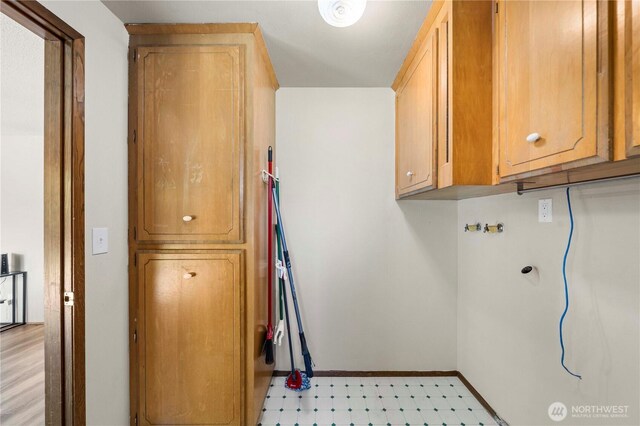 4621 Village Cir SE, Olympia, WA 98501 - washroom with cabinet space, light flooring, baseboards, and washer hookup