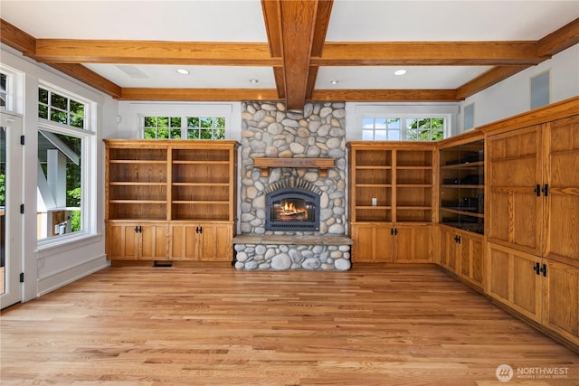 4155 212th Way SE, Sammamish, WA 98075 - unfurnished living room featuring beam ceiling, light wood-style floors, healthy amount of natural light, a stone fireplace, and coffered ceiling
