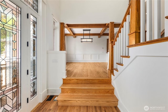 4155 212th Way SE, Sammamish, WA 98075 - stairway featuring beamed ceiling, wood finished floors, coffered ceiling, and a wainscoted wall