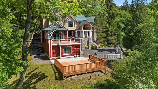 4155 212th Way SE, Sammamish, WA 98075 - back of property with metal roof, a standing seam roof, a wooden deck, a yard, and stairs