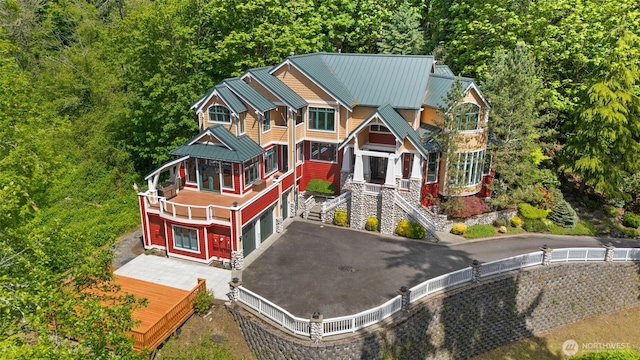 4155 212th Way SE, Sammamish, WA 98075 - view of front of house with an attached garage, metal roof, a standing seam roof, asphalt driveway, and a forest view