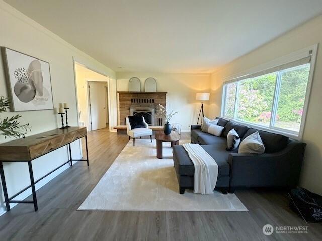 11519 SE 169th St, Renton, WA 98055 - living area featuring wood finished floors and a fireplace with raised hearth