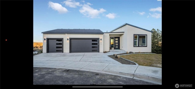 3312 Bing St, West Richland, WA 99353 - contemporary home featuring a garage, driveway, and stucco siding