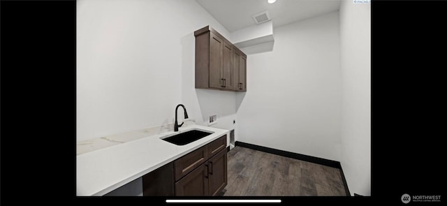 3312 Bing St, West Richland, WA 99353 - laundry room featuring cabinet space, hookup for an electric dryer, hookup for a washing machine, wood finished floors, and baseboards