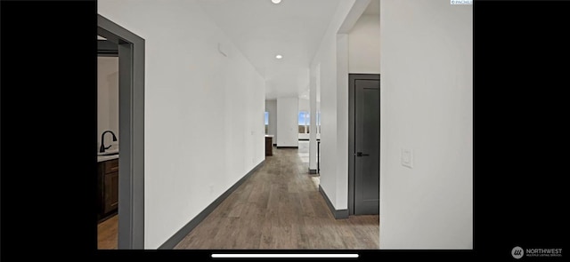 3312 Bing St, West Richland, WA 99353 - corridor with wood finished floors, baseboards, a sink, and recessed lighting