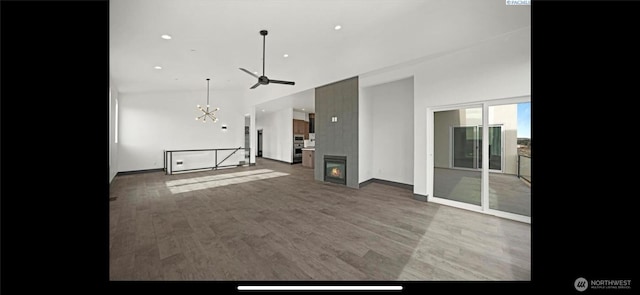 3312 Bing St, West Richland, WA 99353 - unfurnished living room with wood finished floors, a chandelier, baseboards, a ceiling fan, and recessed lighting