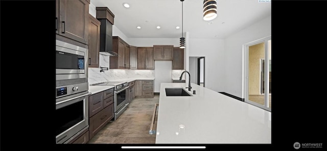 3312 Bing St, West Richland, WA 99353 - kitchen with a sink, appliances with stainless steel finishes, backsplash, light countertops, and light wood-style flooring