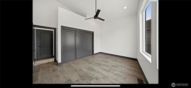 3312 Bing St, West Richland, WA 99353 - unfurnished bedroom with wood finished floors, high vaulted ceiling, a ceiling fan, and baseboards