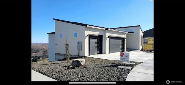 3312 Bing St, West Richland, WA 99353 - view of side of property featuring an attached garage, stucco siding, and driveway
