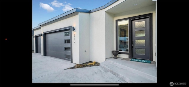 3312 Bing St, West Richland, WA 99353 - property entrance with driveway, a garage, and stucco siding