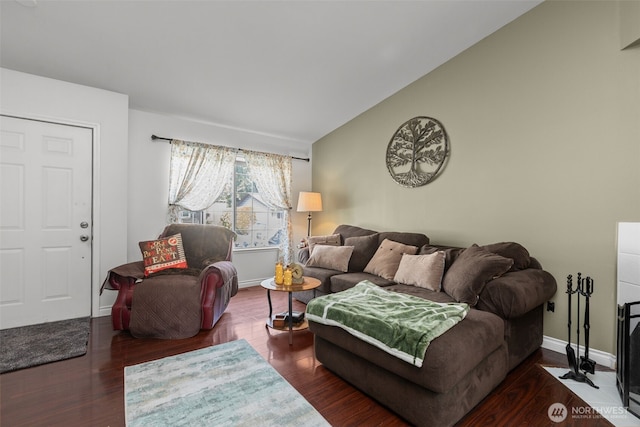 living room with wood finished floors, baseboards, and lofted ceiling