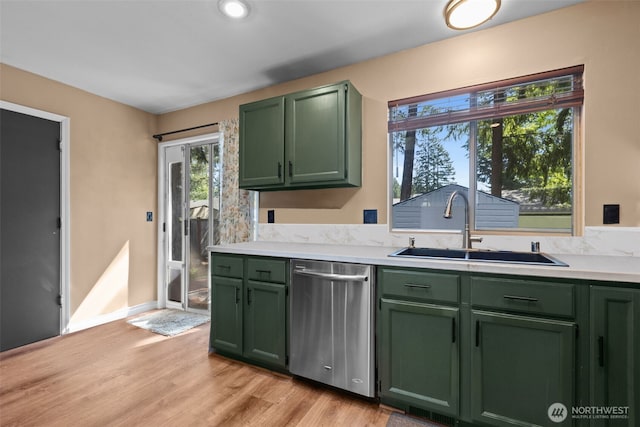 kitchen with green cabinets, dishwasher, a sink, and light countertops