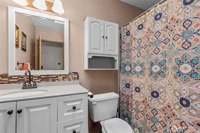 bathroom featuring backsplash, vanity, toilet, and a shower with shower curtain