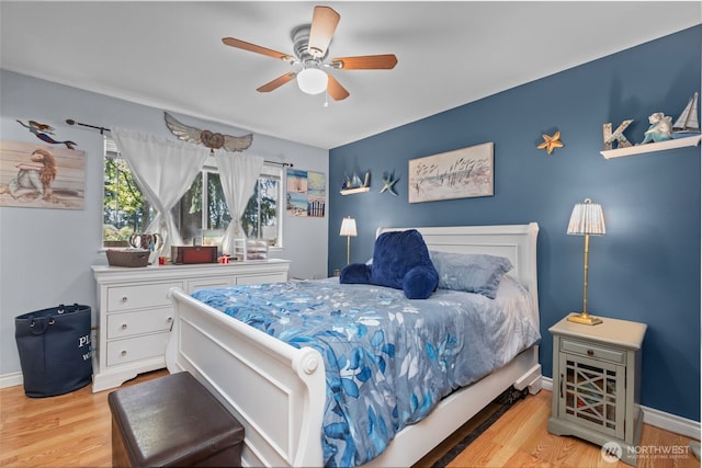 bedroom with wood finished floors, baseboards, and ceiling fan