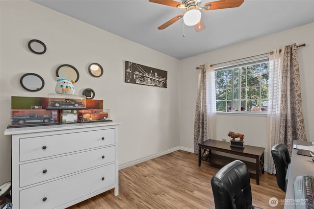 living area with ceiling fan, light wood-type flooring, a desk, and baseboards
