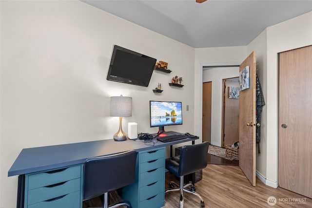 office featuring light wood-type flooring and baseboards