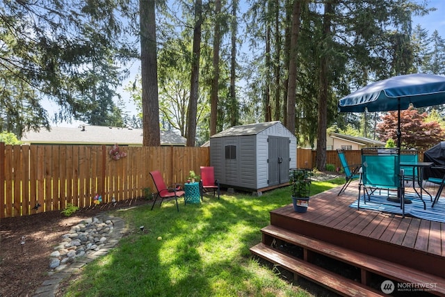 view of yard featuring a storage unit, a deck, outdoor dining area, and an outdoor structure