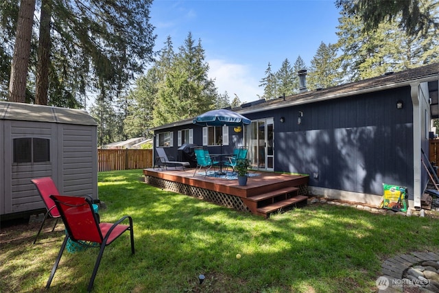 view of yard featuring a shed, a wooden deck, and an outdoor structure