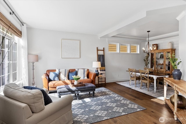 living area featuring a chandelier, dark wood-style floors, and baseboards