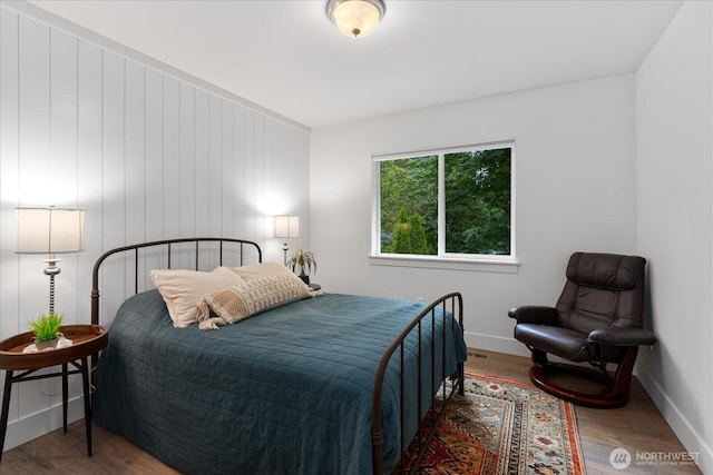 bedroom featuring wood finished floors and baseboards
