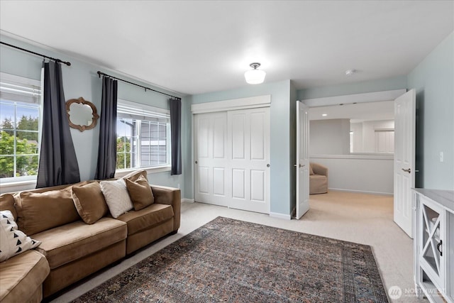 carpeted living room featuring baseboards