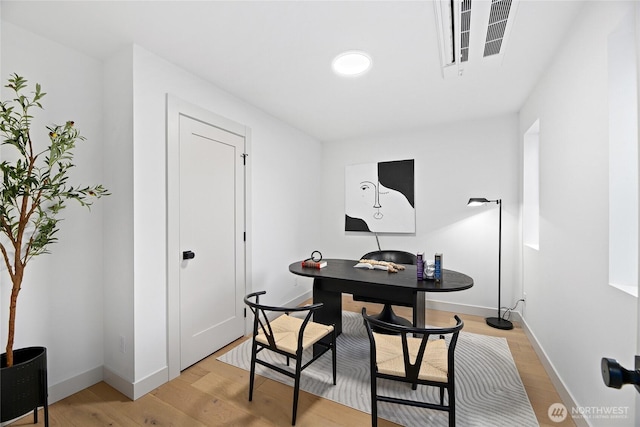 office area featuring light wood-type flooring and baseboards