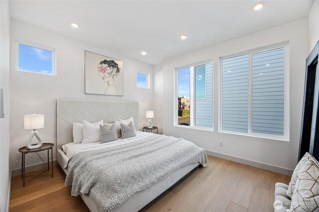 bedroom featuring light wood-type flooring, baseboards, and recessed lighting
