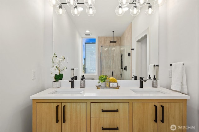 full bathroom with a chandelier, a stall shower, and double vanity