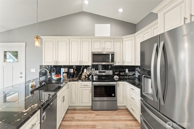 626 Duck Lake Dr SE, Ocean Shores, WA 98569 - kitchen with stainless steel appliances, a sink, tasteful backsplash, light wood-style floors, and pendant lighting