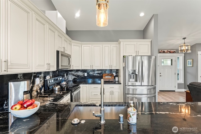 626 Duck Lake Dr SE, Ocean Shores, WA 98569 - kitchen with appliances with stainless steel finishes, dark stone counters, and decorative backsplash