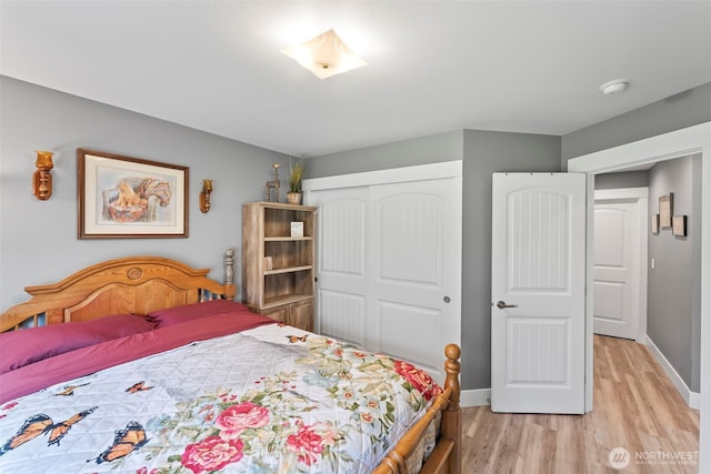 626 Duck Lake Dr SE, Ocean Shores, WA 98569 - bedroom with light wood finished floors, a closet, and baseboards