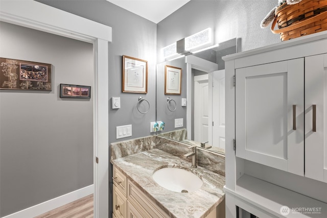626 Duck Lake Dr SE, Ocean Shores, WA 98569 - bathroom with vanity, wood finished floors, and baseboards