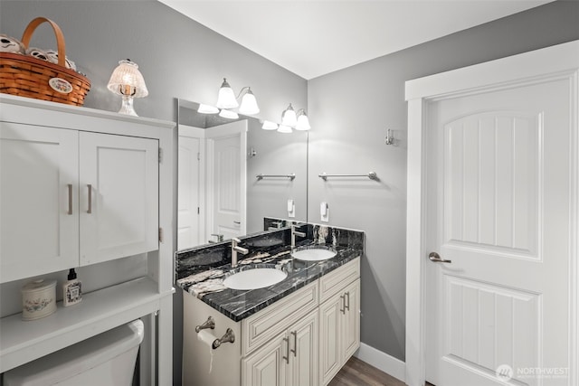 626 Duck Lake Dr SE, Ocean Shores, WA 98569 - bathroom with double vanity, toilet, and wood finished floors