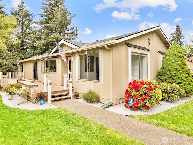 12120 A St S, Tacoma, WA 98444 - view of property exterior featuring a wooden deck, a yard, and a shingled roof