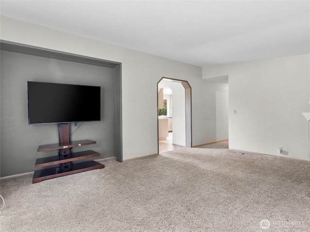 12120 A St S, Tacoma, WA 98444 - unfurnished living room featuring arched walkways, carpet flooring, and baseboards